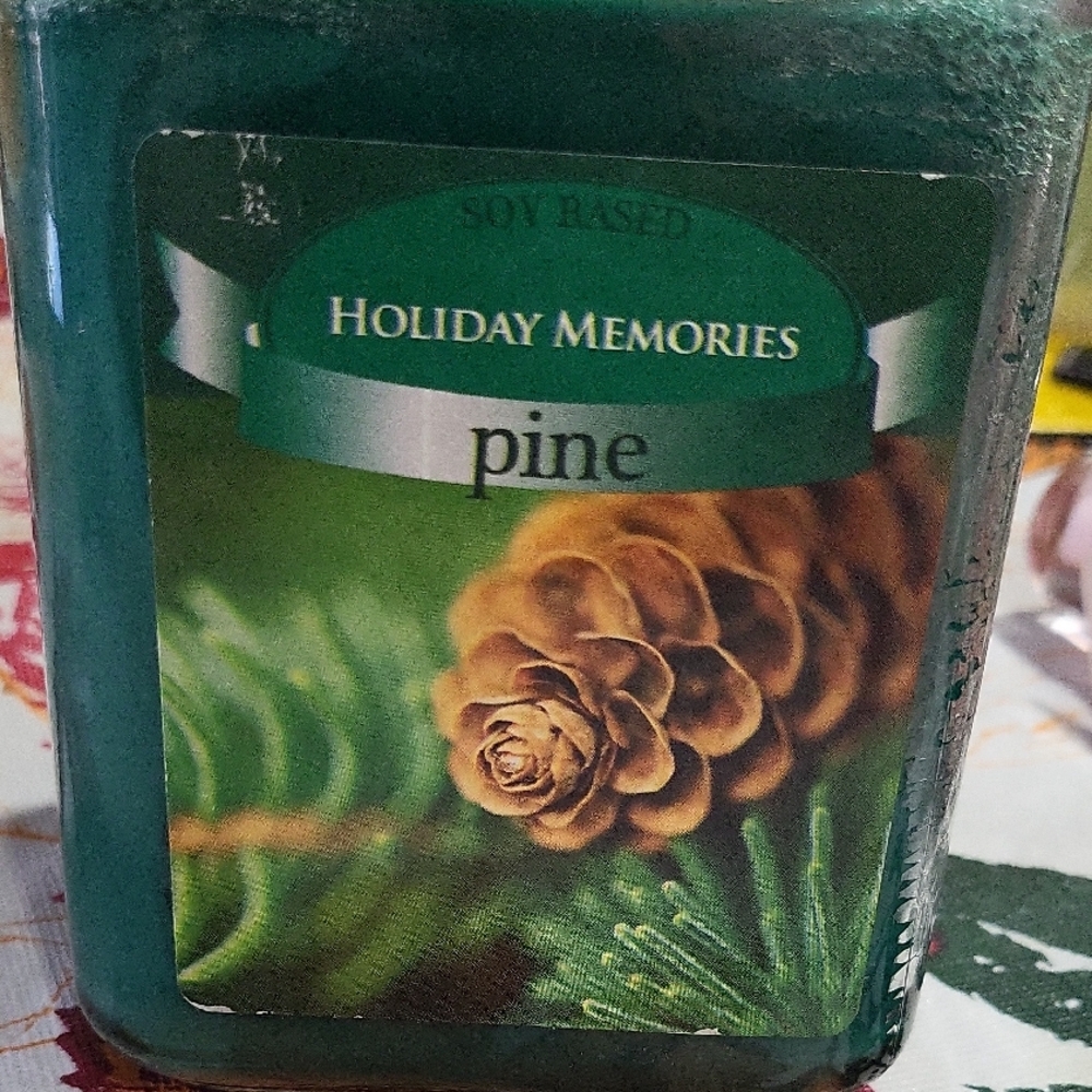 Holiday Memories" pine scented soy-based candle.